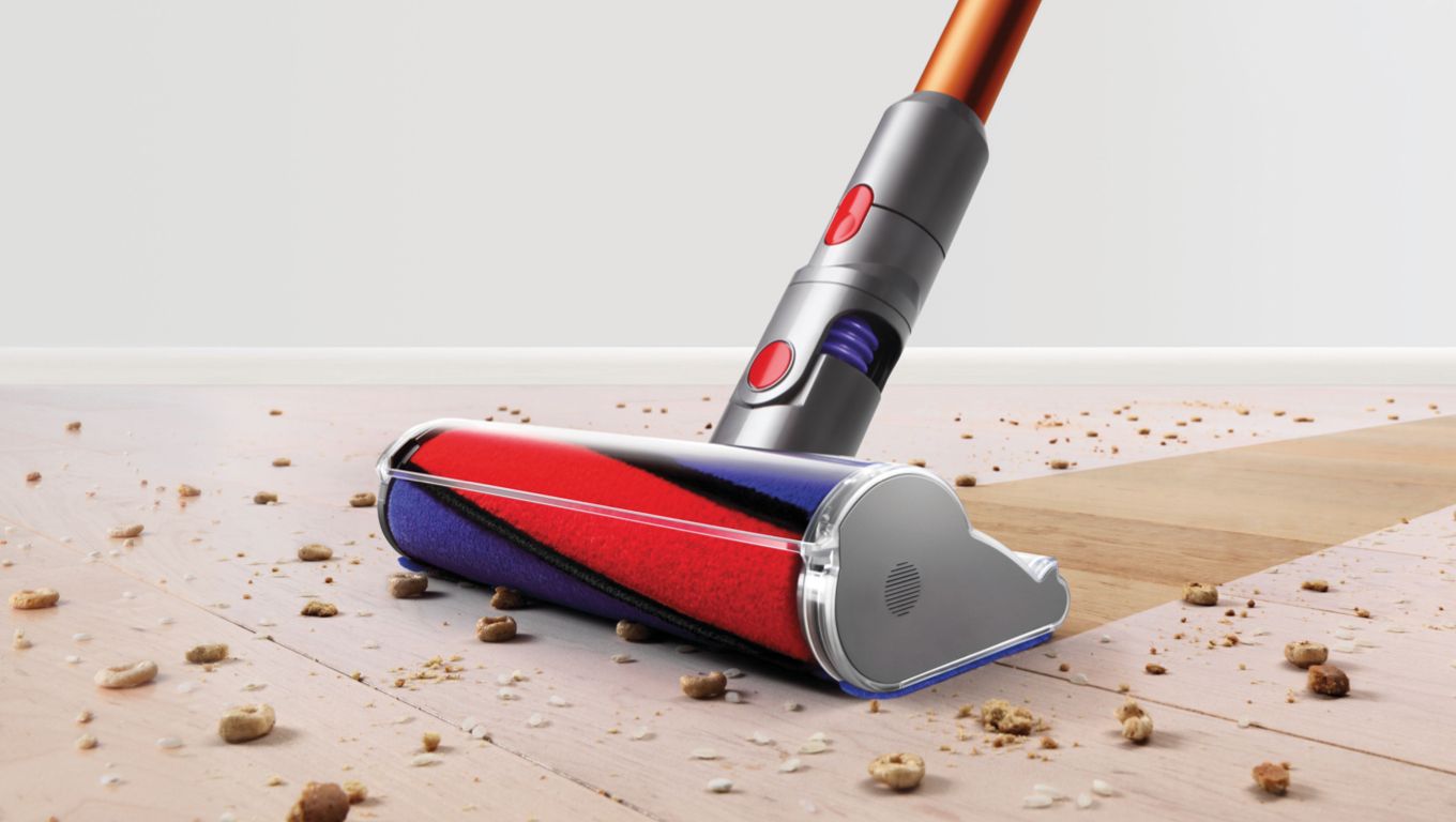 Dyson Cyclone V10™ vacuum in handheld mode cleaning car seat Dyson Cyclone V10™ vacuum in handheld mode cleaning car seat